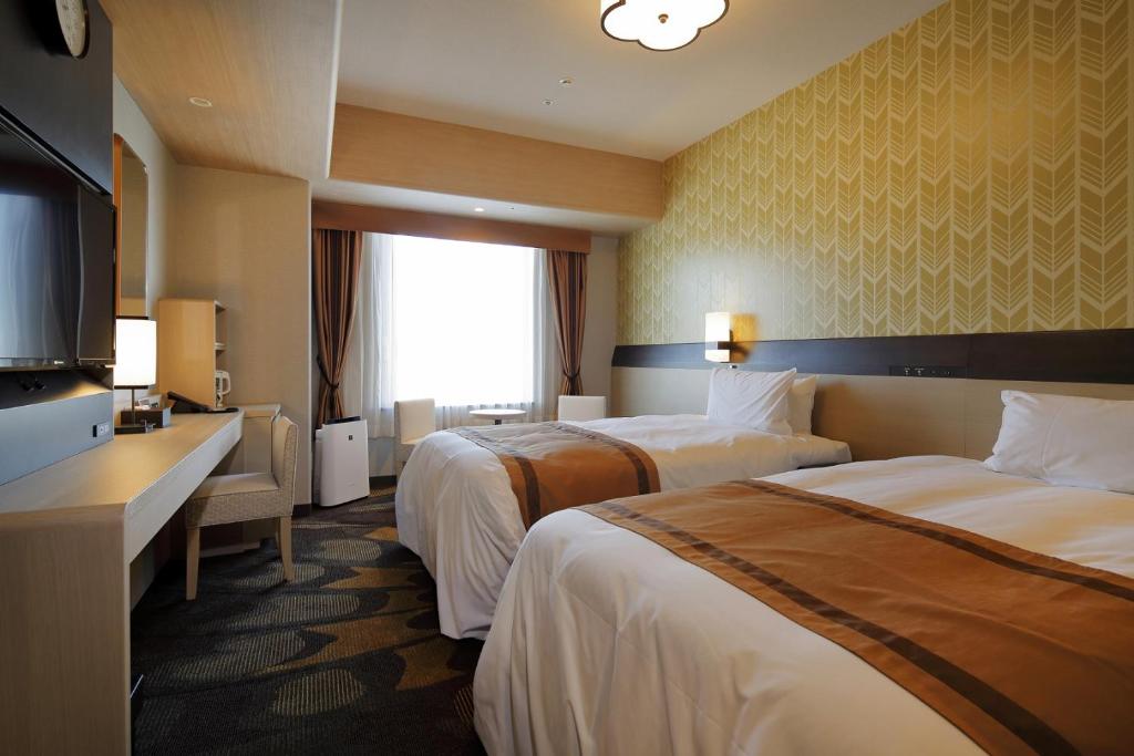 Postel nebo postele na pokoji v ubytování Hotel Monterey Himeji
