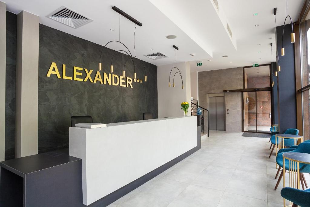 an office lobby with a reception desk and chairs at Hotel Alexander in Krakow
