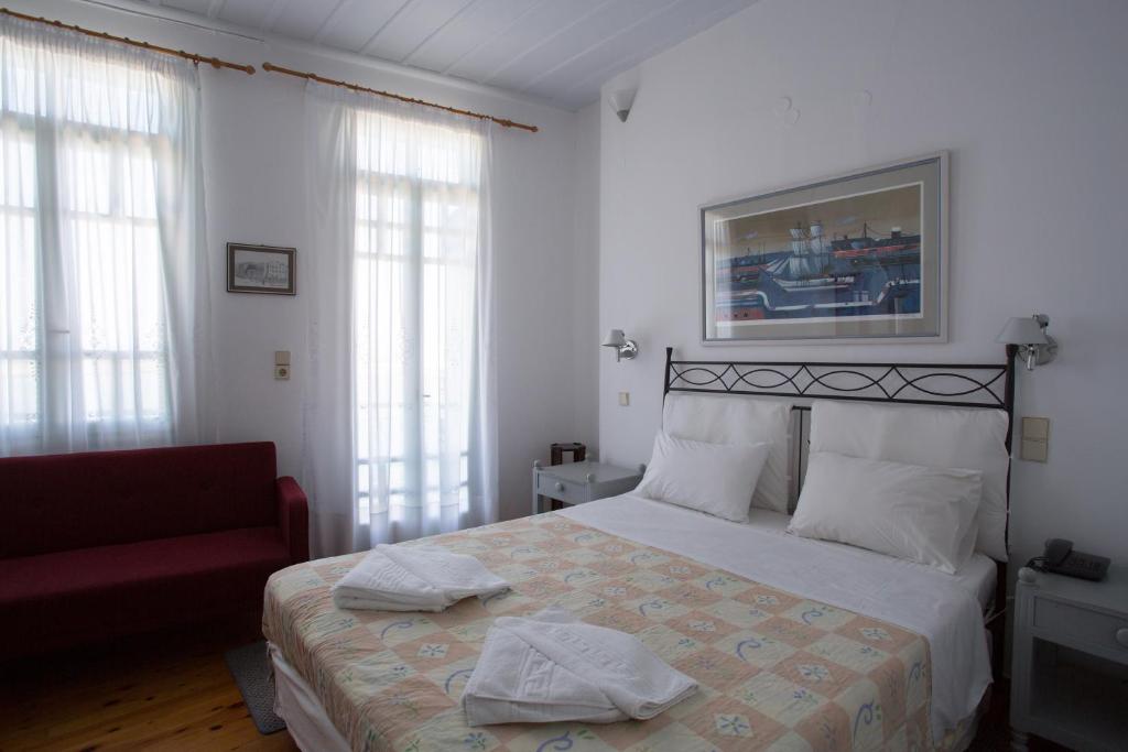 Postel nebo postele na pokoji v ubytování Nostos Hotel