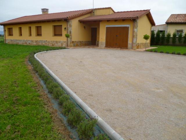 a driveway in front of a house with a garage at Raitana in Villar