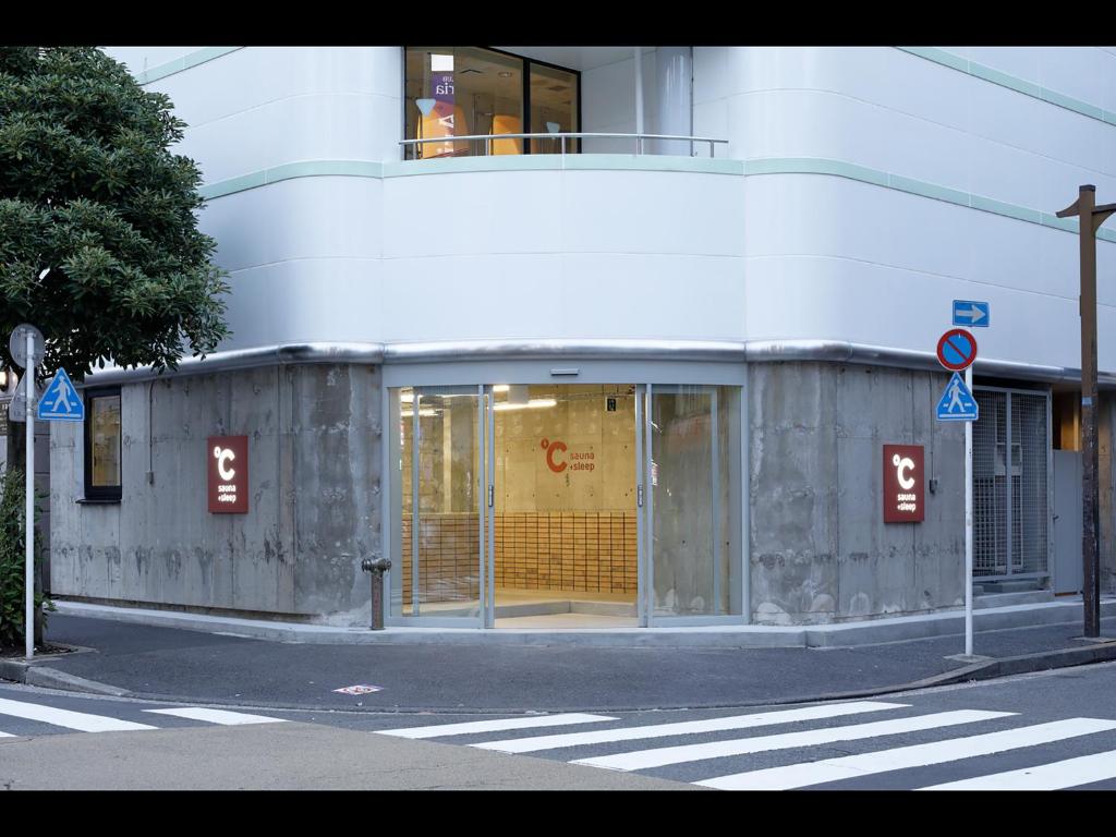 a building on the corner of a street at Do-C Gotanda in Tokyo