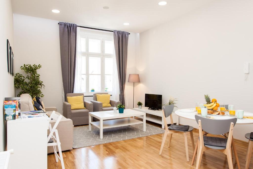 a living room with a couch and a table at Luxury Main Square Apartments in Zagreb