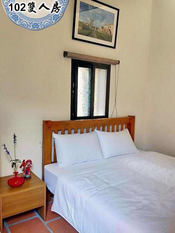 Postel nebo postele na pokoji v ubytování Kinmen Huquian 58