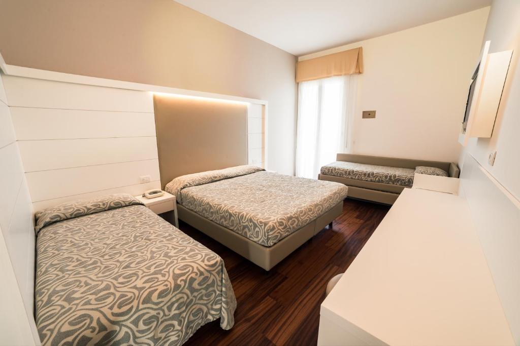 Postel nebo postele na pokoji v ubytování Hotel Alexander
