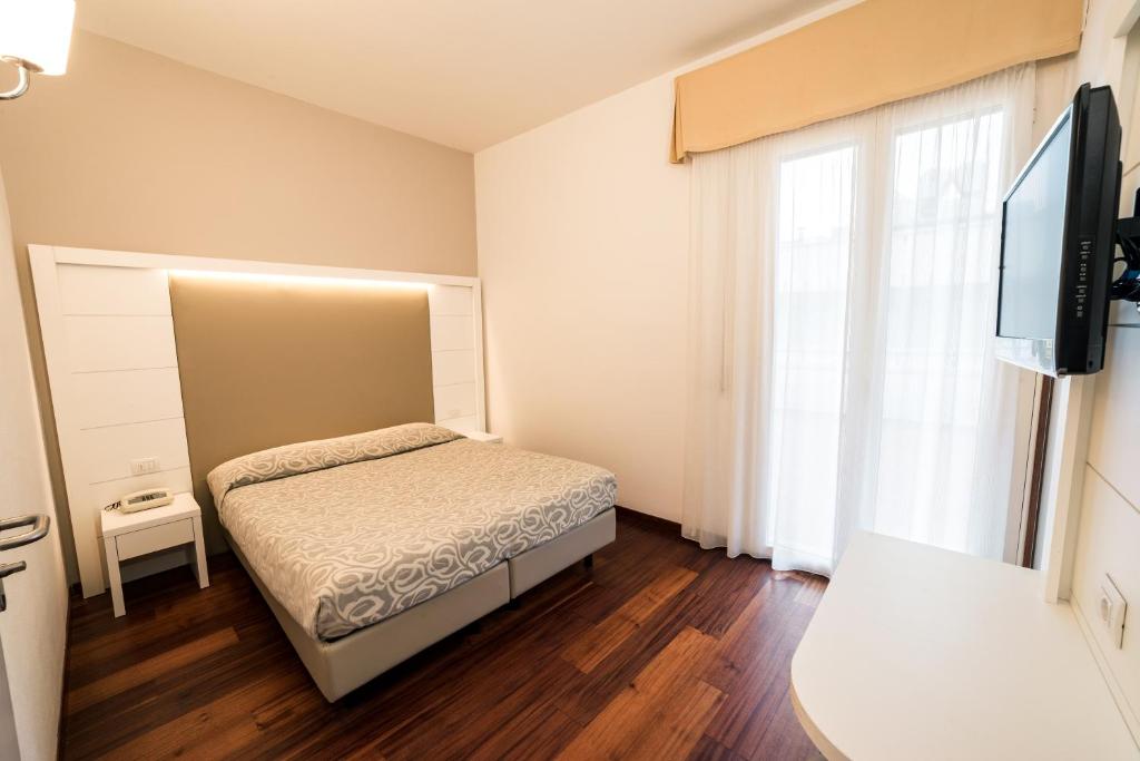 Postel nebo postele na pokoji v ubytování Hotel Alexander