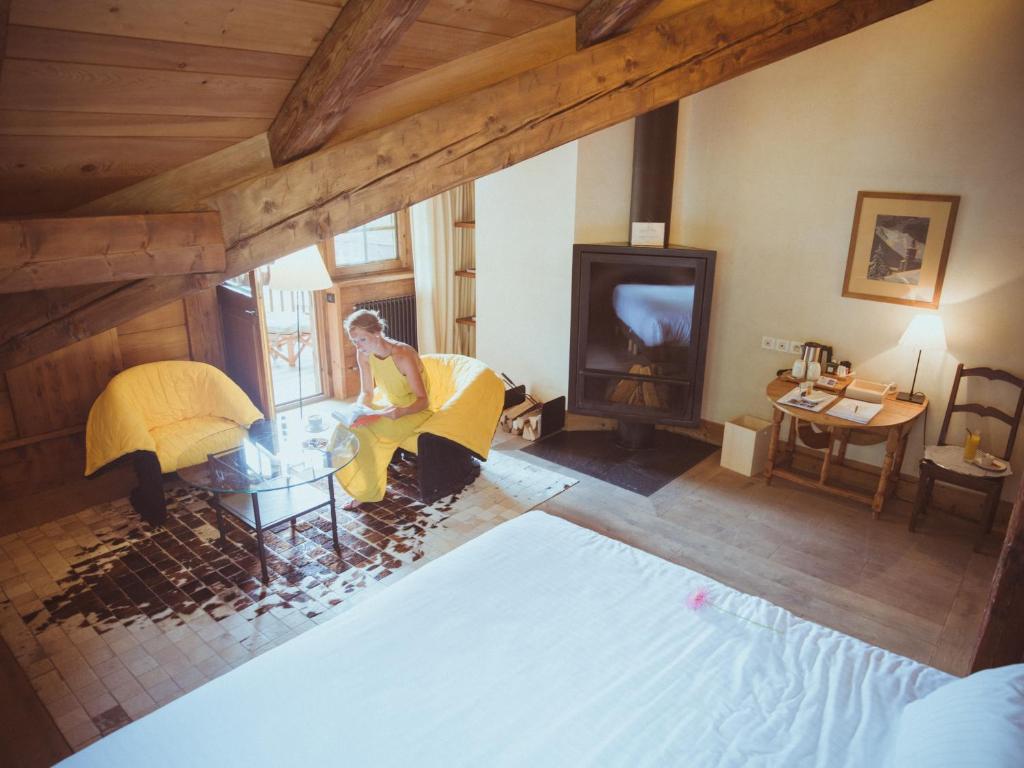 an overhead view of a woman sitting in a living room at Le Hameau Albert 1er in Chamonix