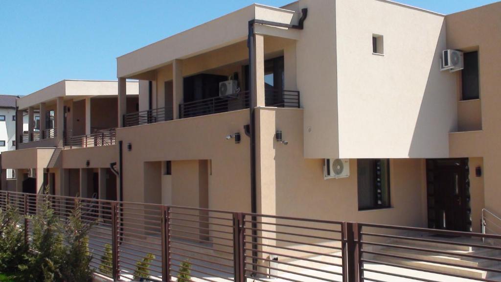 a building with balconies on the side of it at Vila Ando Mamaia Nord in Mamaia Sat/Năvodari