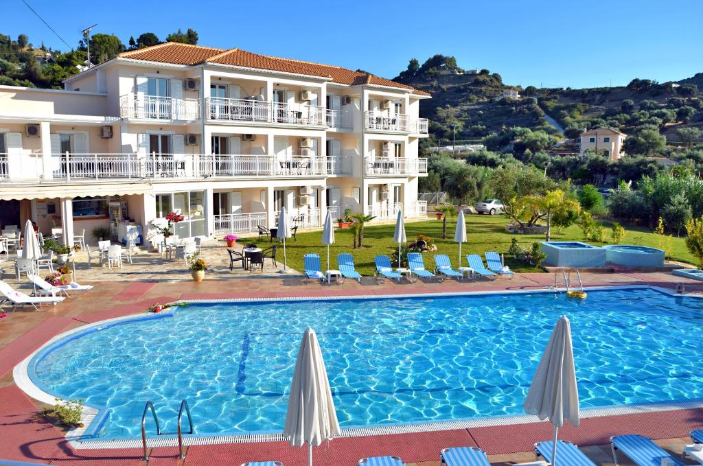 a large swimming pool in front of a building at Elea Hotel Apartments and Villas in Argassi