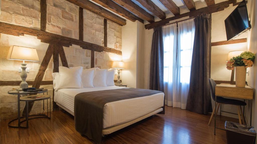 
a bedroom with a bed and a dresser at Abad Toledo in Toledo
