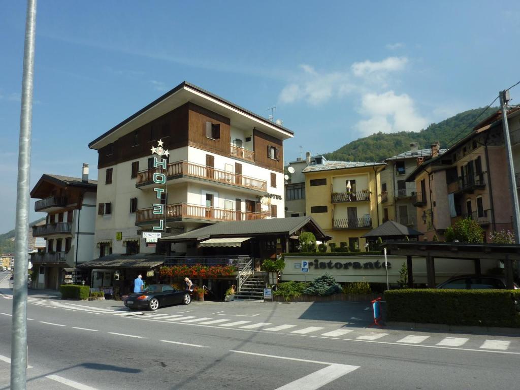 a building with a car parked next to a street at Albergo Nazionale in Vernante