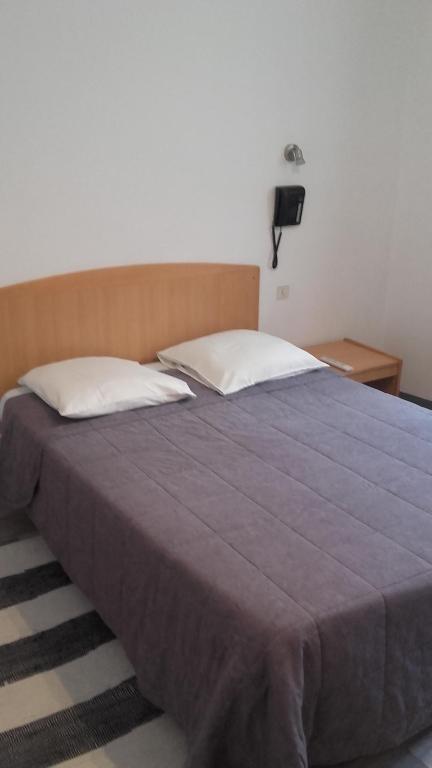 Postel nebo postele na pokoji v ubytování Hotel Le Chapitre