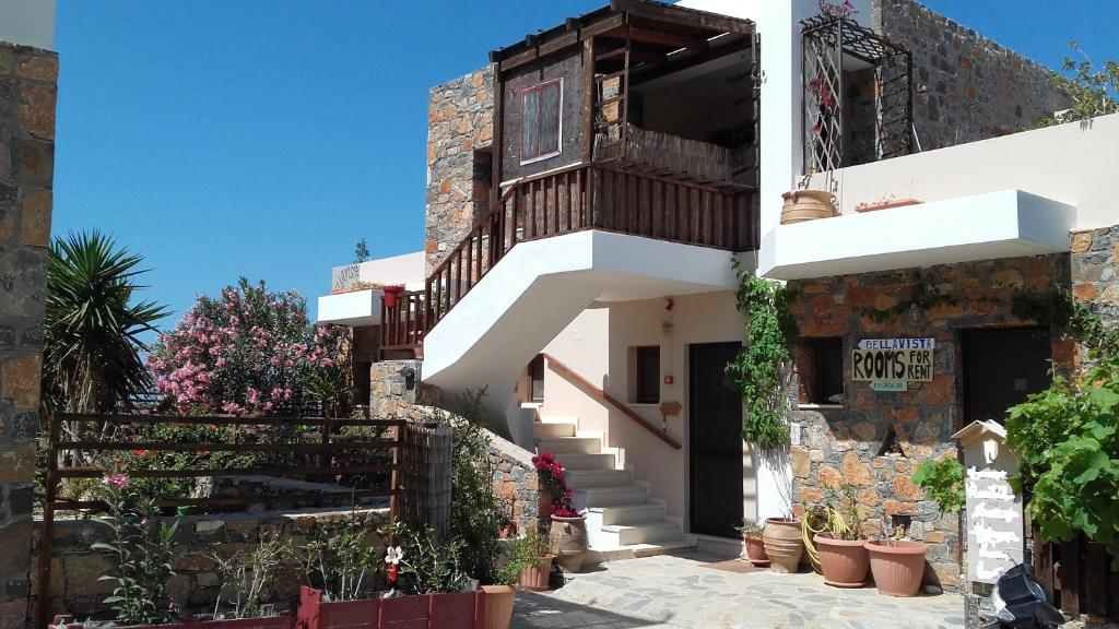 a building with stairs and plants in front of it at Bellavista in Mochlos