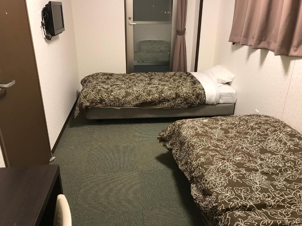 Postel nebo postele na pokoji v ubytování Hotel Famitic Nikko Station