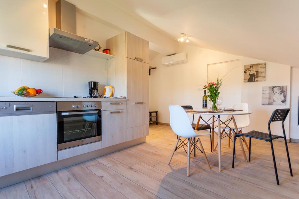 a kitchen and dining room with a table and chairs at Apartment Egon in Malinska