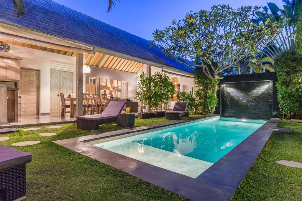 a swimming pool in the backyard of a house at VILLA Nuri Merah 1 in Kerobokan