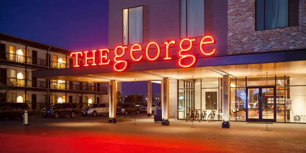 a neon sign on the side of a building at The George in College Station