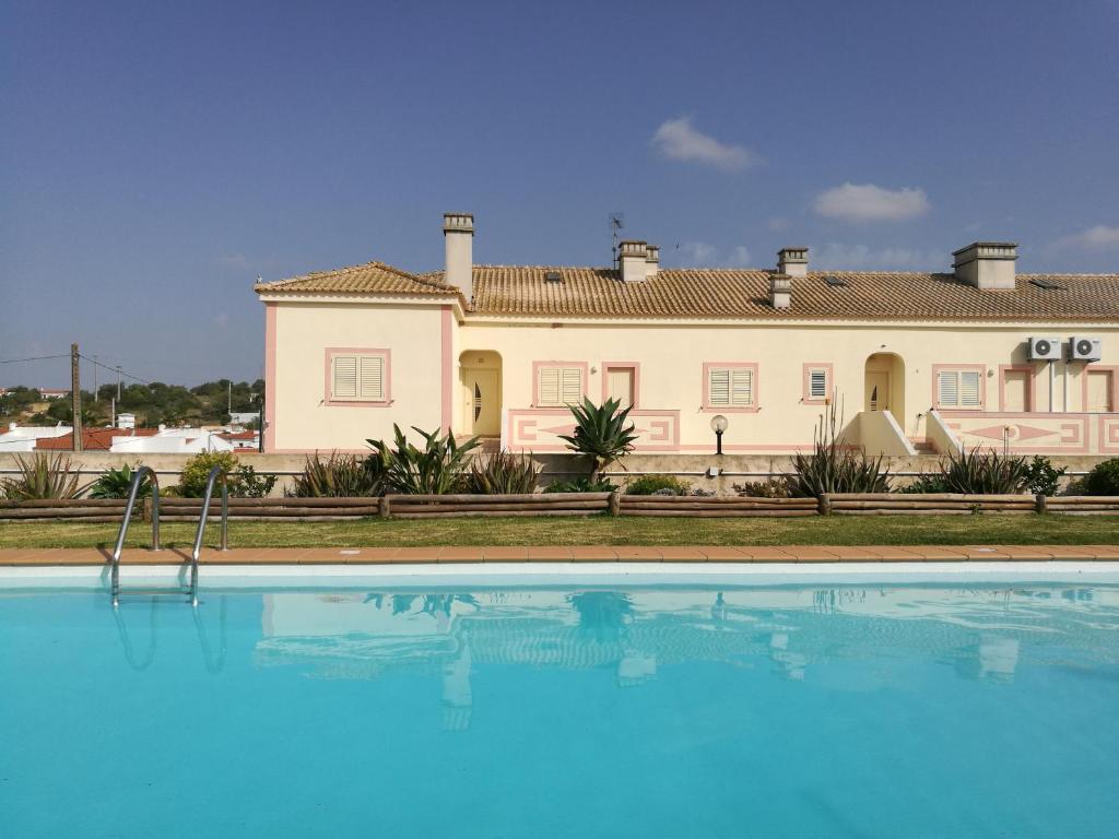 a large house with a swimming pool in front of it at Apartamento Patel in Poço Partido