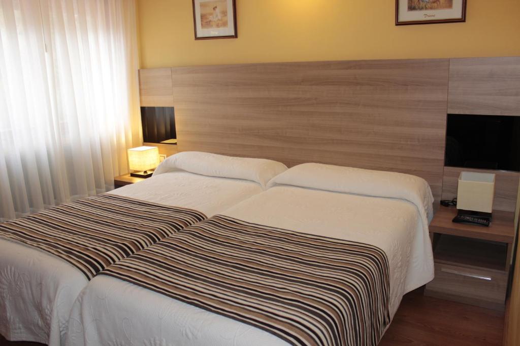 Postel nebo postele na pokoji v ubytování Hotel Peñagrande