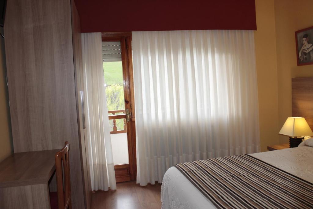Postel nebo postele na pokoji v ubytování Hotel Peñagrande