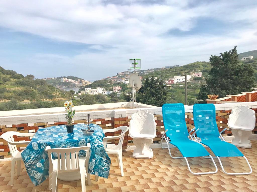 a patio with a table and chairs on a roof at Conti Holiday Homes in Ponza