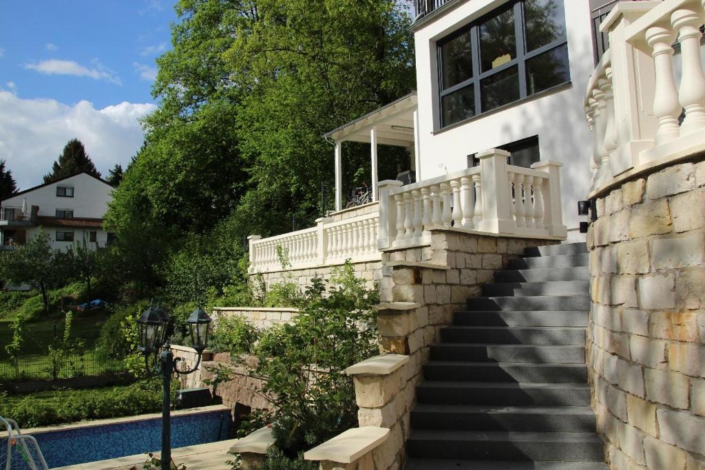 a house with a staircase leading up to a house at holidayhome Heidelberg in Heidelberg