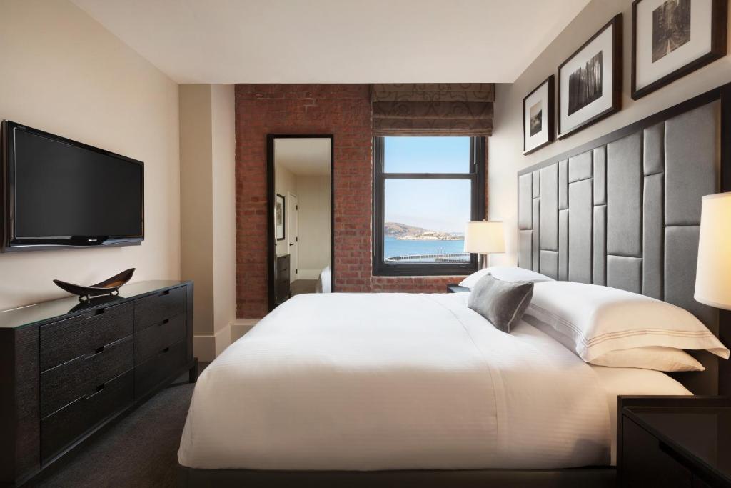 a bedroom with a bed and a television at The Fairmont Heritage Place Ghirardelli Square in San Francisco