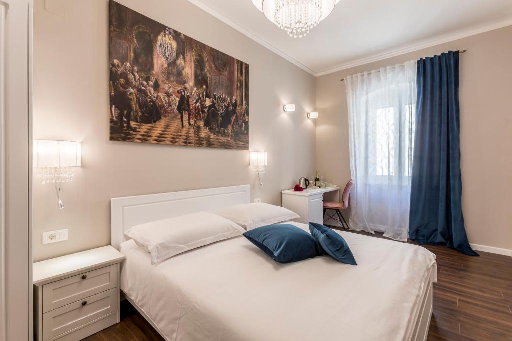 a bedroom with a bed with a painting on the wall at Theatre of Dreams Rooms in Split