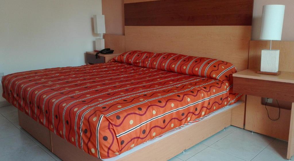Postel nebo postele na pokoji v ubytování Hotel Real Zapopan