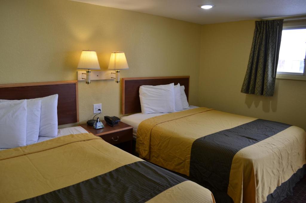 a hotel room with two beds and a window at Budget Inn Williamsville in Williamsville