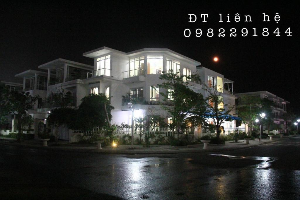 a large white building on a street at night at Ngoc Trai 02 FLC Sam Son in Sầm Sơn