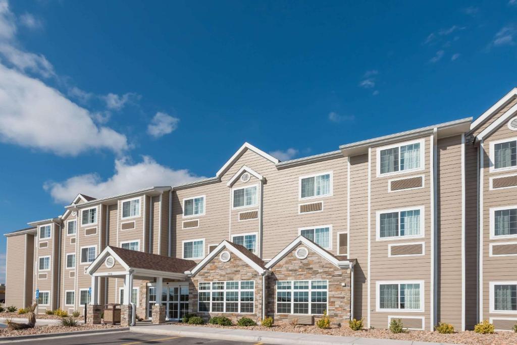 a large apartment building with a blue sky at Microtel Inn & Suites by Wyndham Sweetwater in Sweetwater