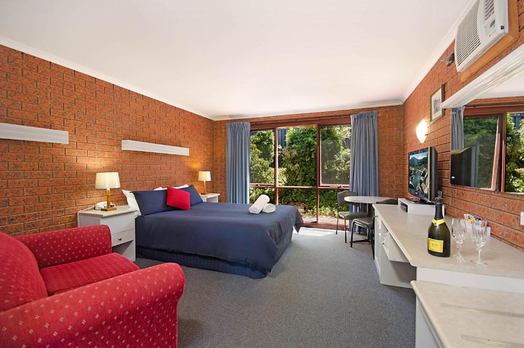 斯蒂基斯霍爾米的住宿－捕鯨者休閒汽車旅館，一间卧室配有一张床、一张沙发和一台电视。