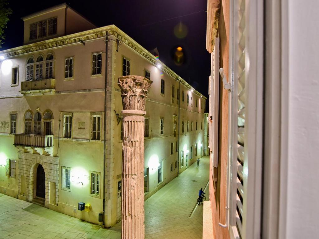 a column in front of a building at night at Luxury room Colonna 4*, center in Zadar