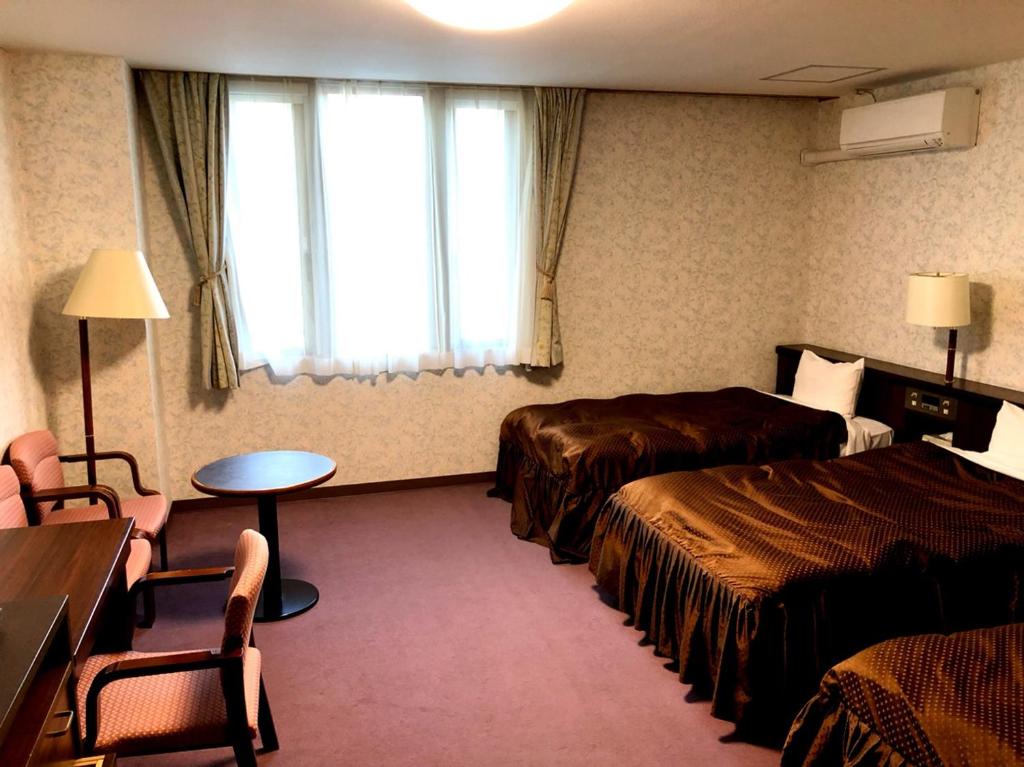 Postel nebo postele na pokoji v ubytování Hotel Oak Forest