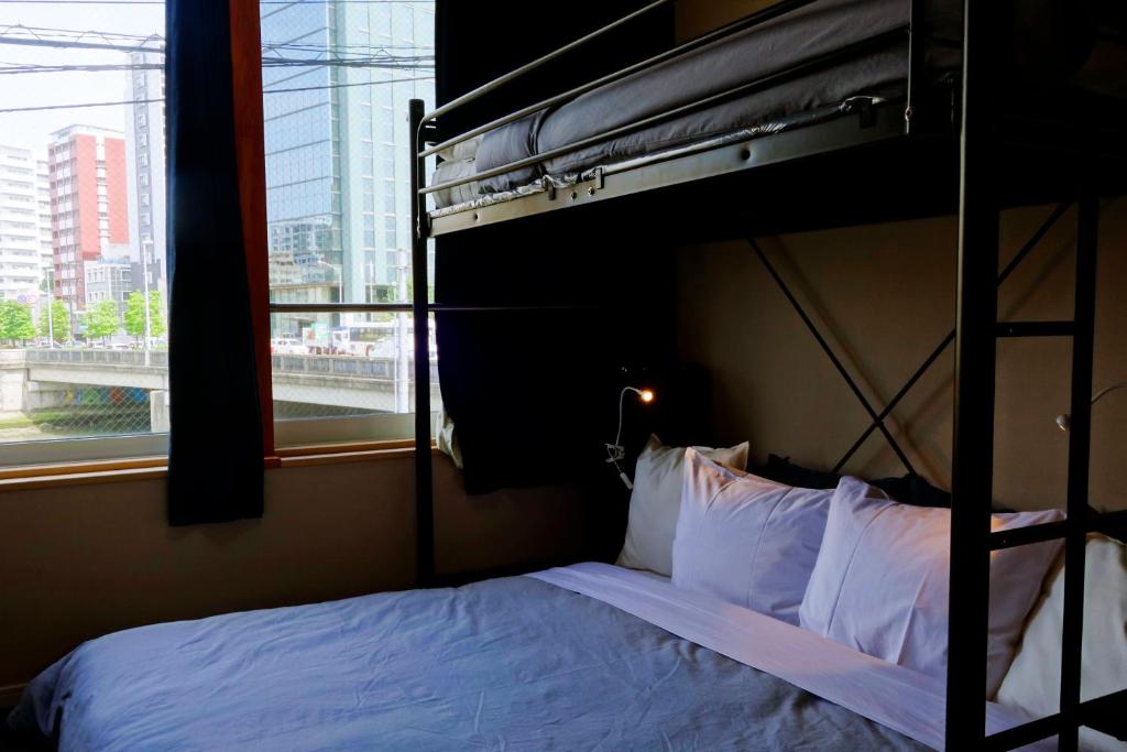 Postel nebo postele na pokoji v ubytování Fukuoka Tabiji Hostel & Guesthouse