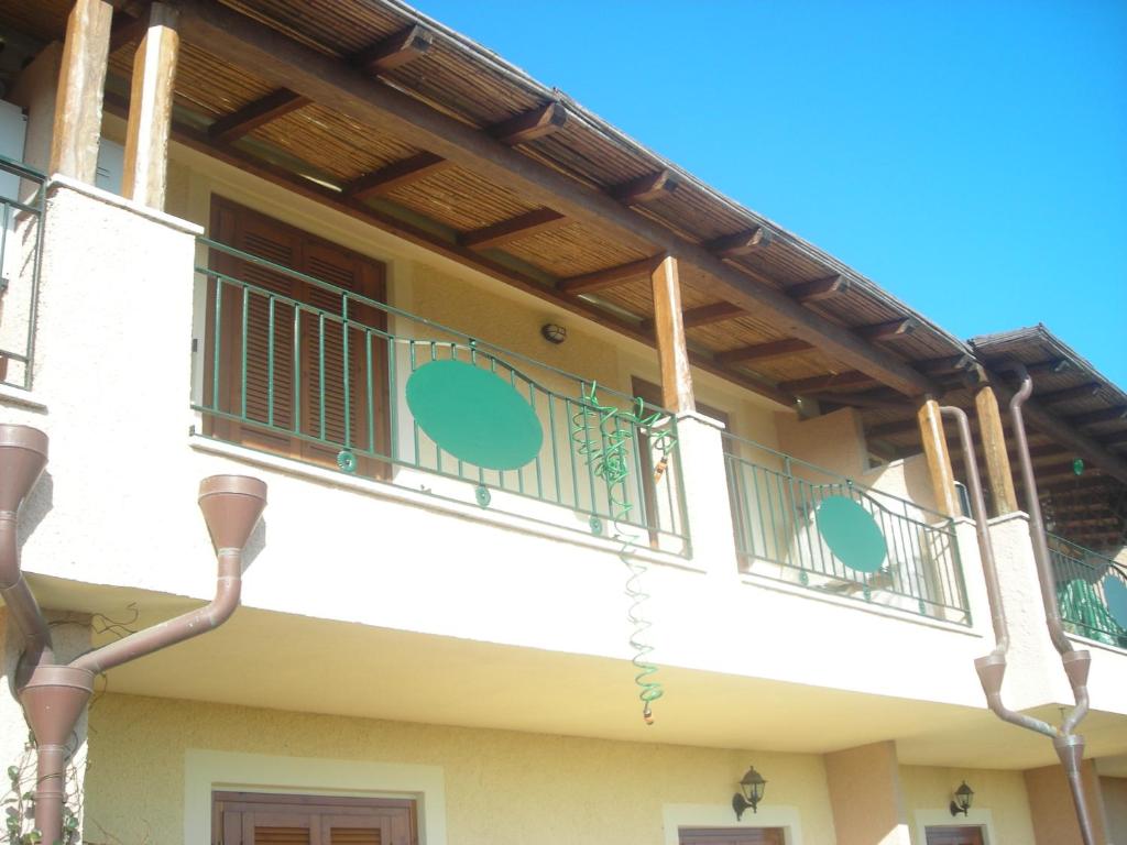 - un balcon dans un bâtiment avec un toit en bois dans l'établissement Olbia Tempio, à Olbia