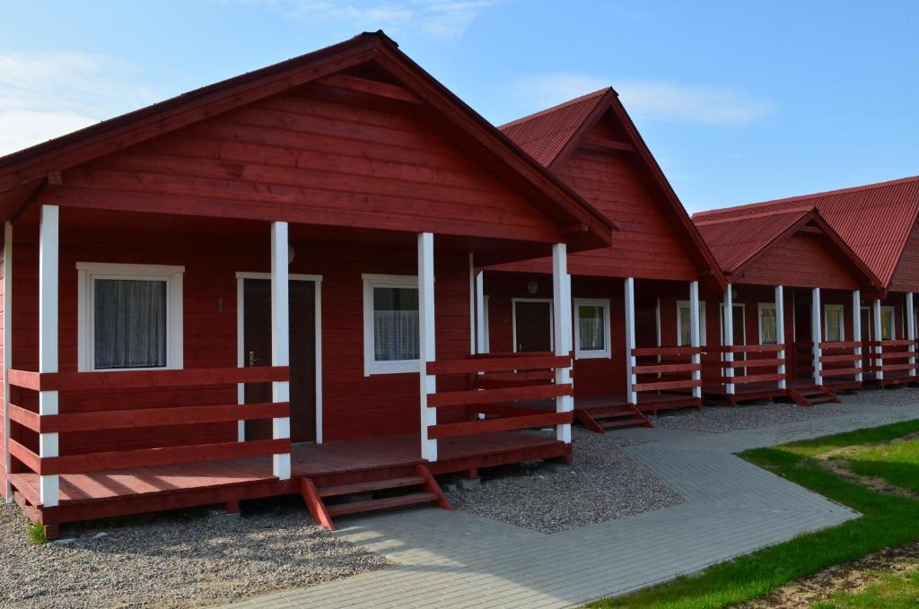 a row of red cabins in a row at Rodzinna Kraina in Ustka