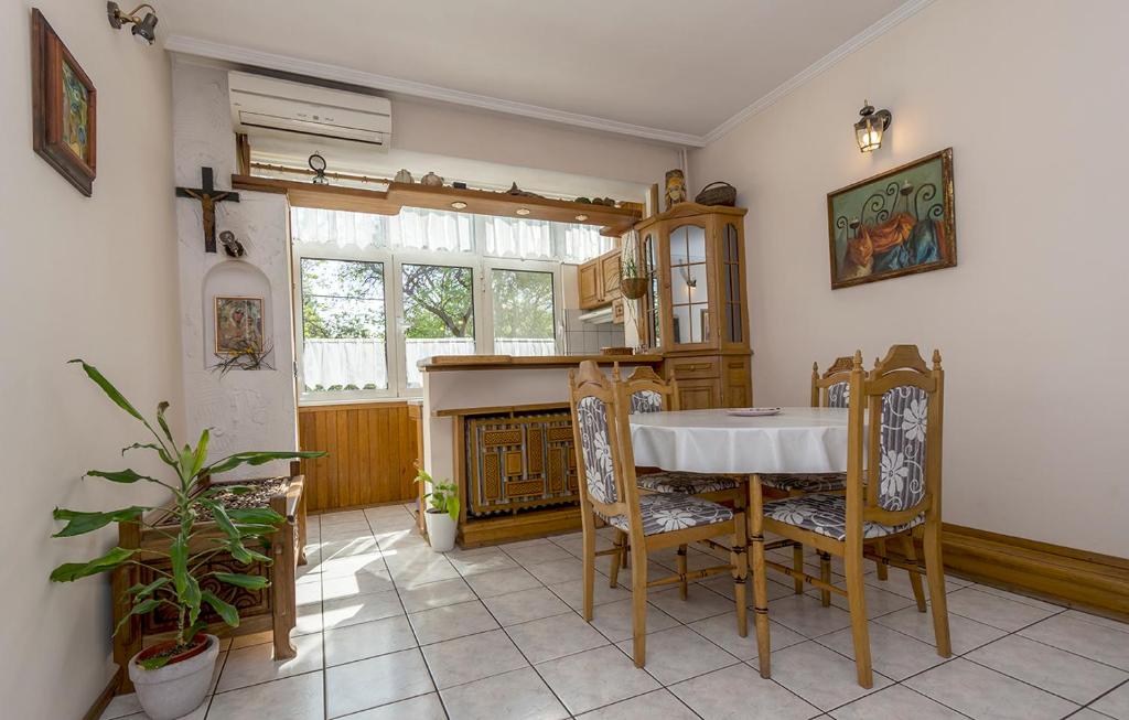 a kitchen with a table and chairs and a fireplace at Апартамент Бриз in Burgas