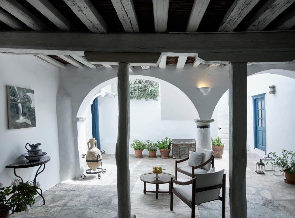 a patio with chairs and a table in a building at Orloff Boutique Hotel in Hydra