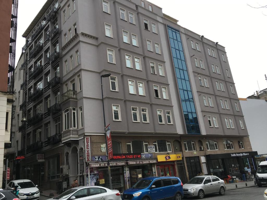 a tall building with cars parked in front of it at Hotel Yonca in Istanbul