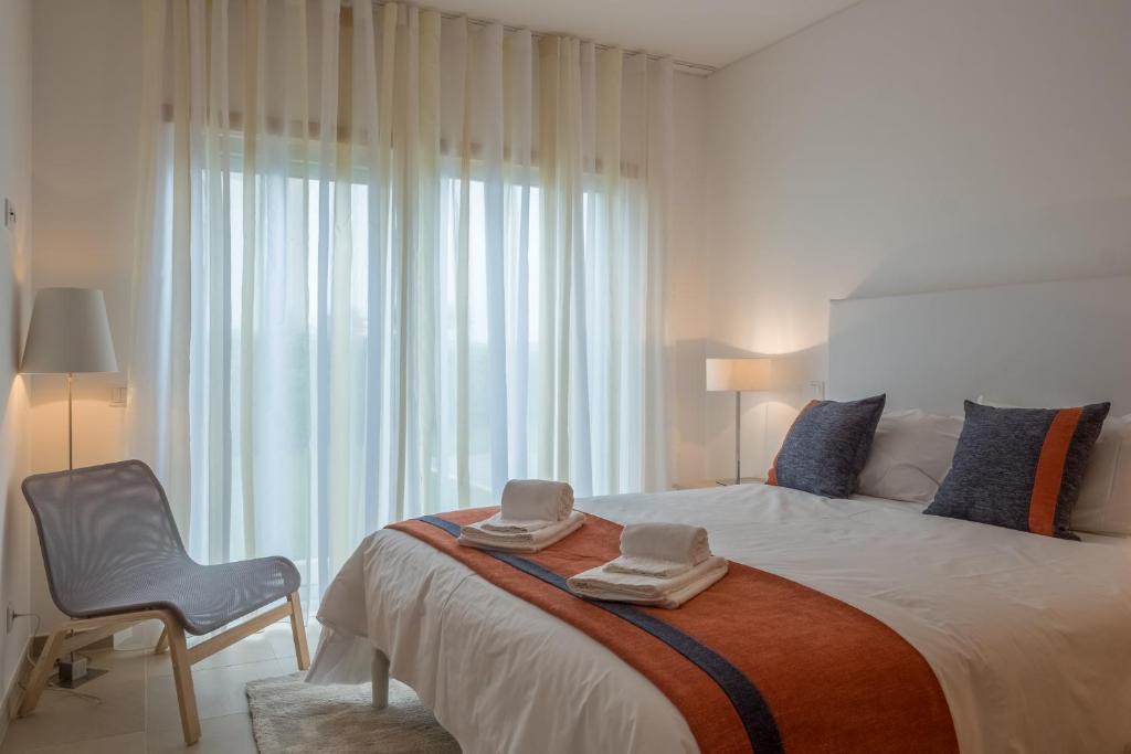 a bedroom with a large bed with two hats on it at Marvellous Villa in Óbidos