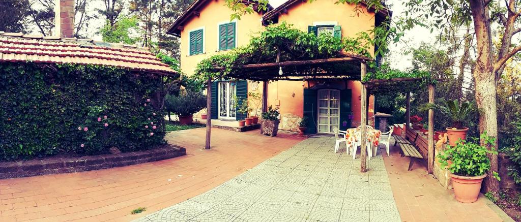 a house with tables and chairs in front of it at Bed and Breakfast Monticelli in Capranica
