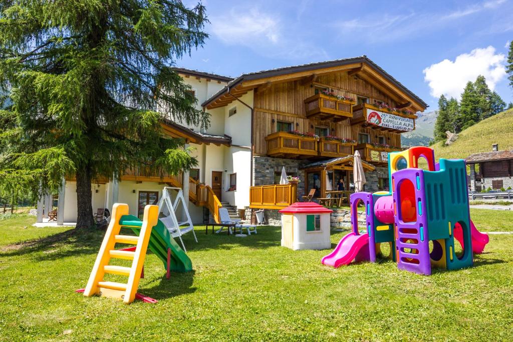 a group of playground equipment in front of a house at Albergo Punta Zerbion in Champoluc