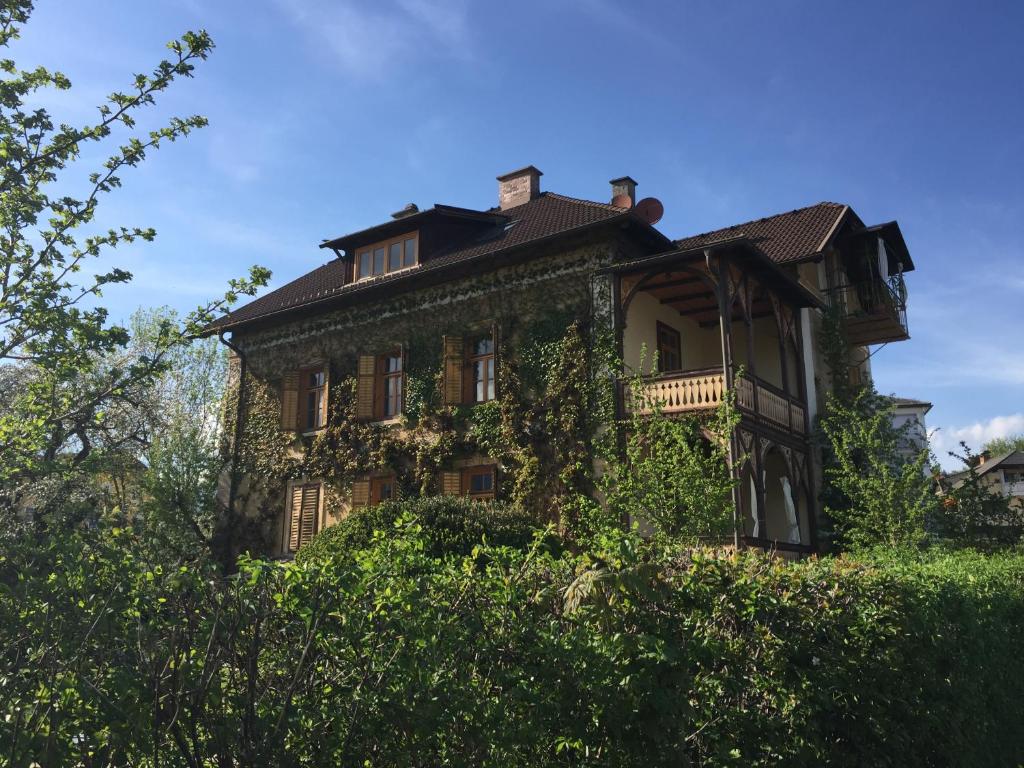 Ein altes Haus mit Efeu nebenbei in der Unterkunft Villa Martiny in Seeboden