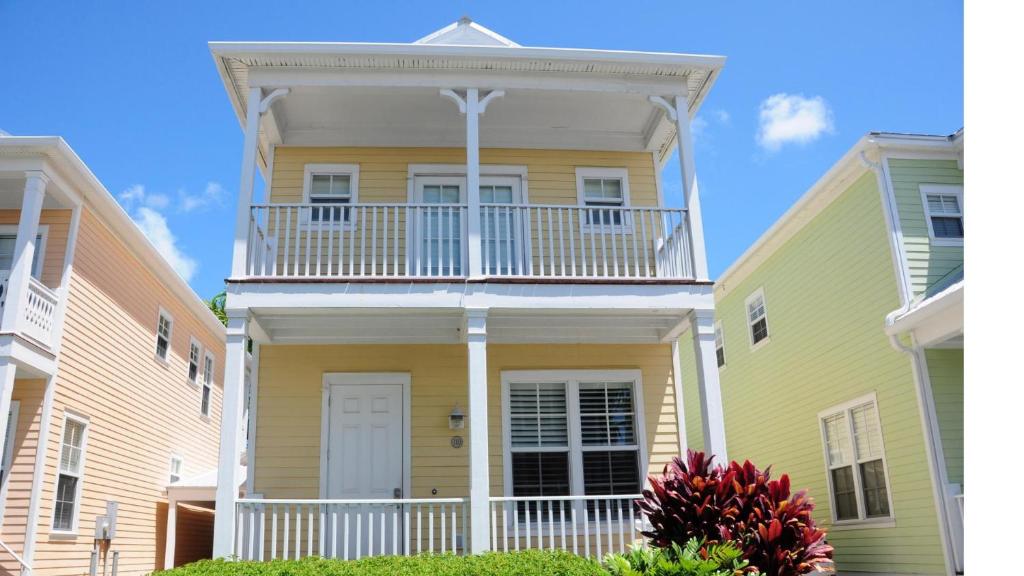 a yellow house with a balcony on top of it at Anglers Reef Paradise in Islamorada