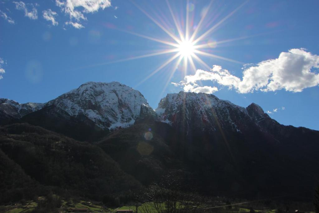 a sun shines over a mountain range at Casa di gianni in Primaluna