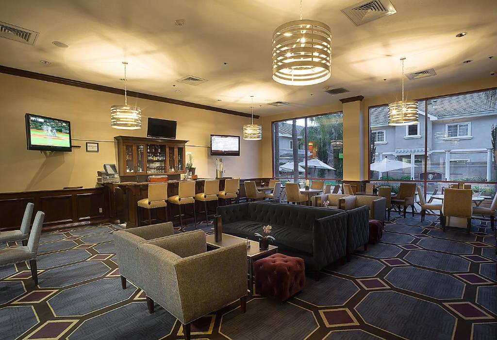 a waiting room with chairs and a bar at Grand Hotel in Sunnyvale