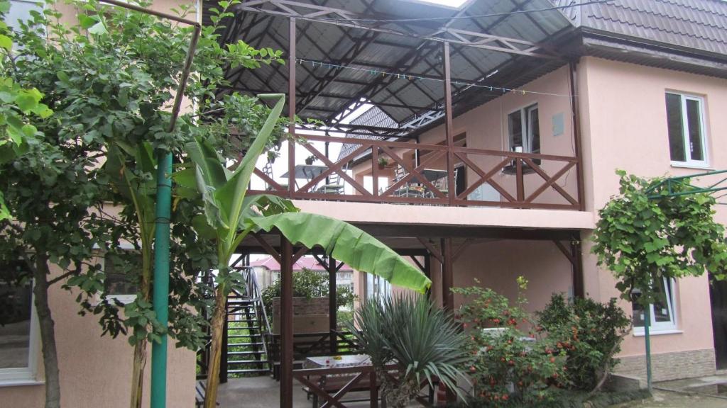 a building with awning and plants in front of it at Samida in Novy Afon