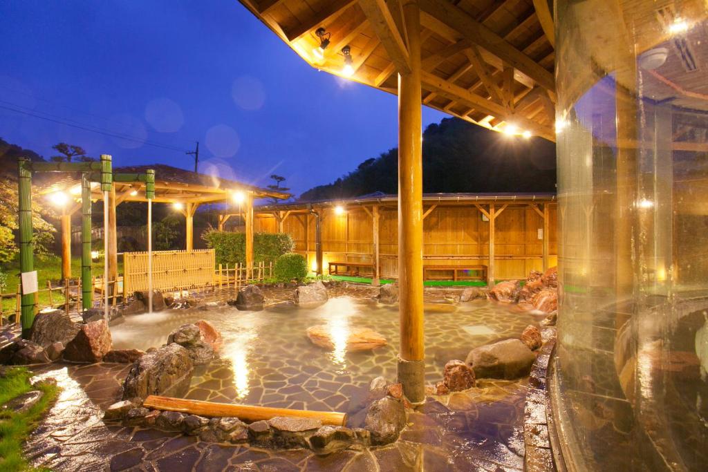 a swimming pool in a building at night at Ichinomata Onsen Grand Hotel in Shimonoseki