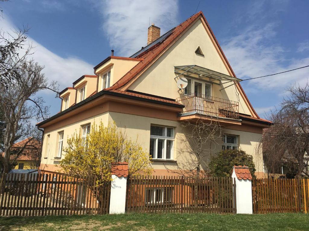 duży biały dom z drewnianym płotem w obiekcie Apartmán Nella w mieście Valtice